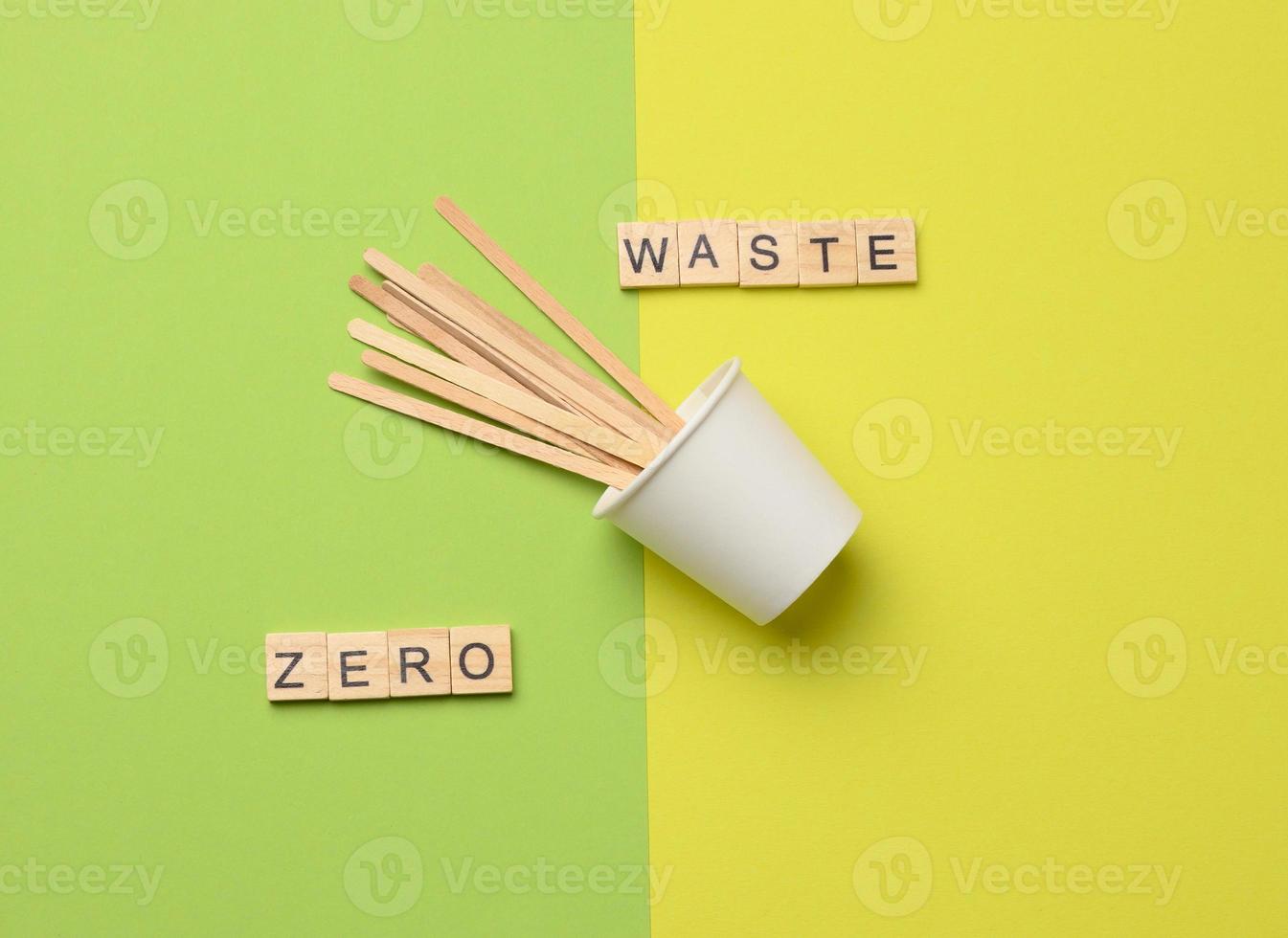 disposable paper cup and wooden stirring sticks, lettering zero waste photo