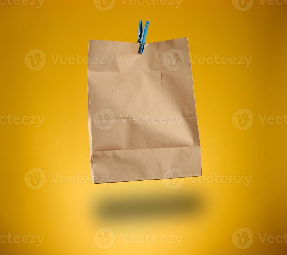 blank brown craft package for products and things on a yellow background photo