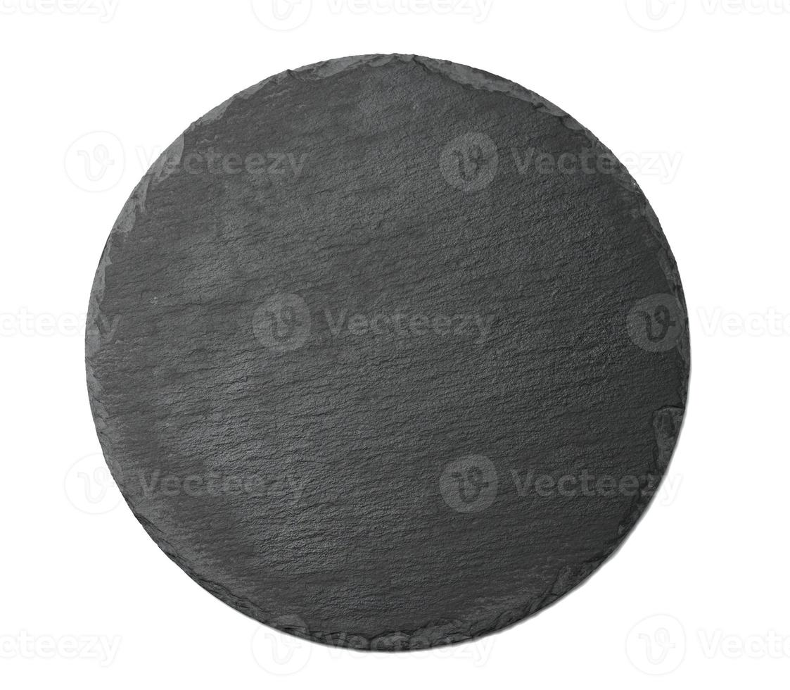 empty black round graphite board for serving dishes isolated on white background photo