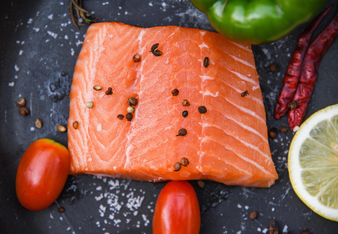 Fresh salmon fillet on dark background Close up of raw salmon fish seafood photo