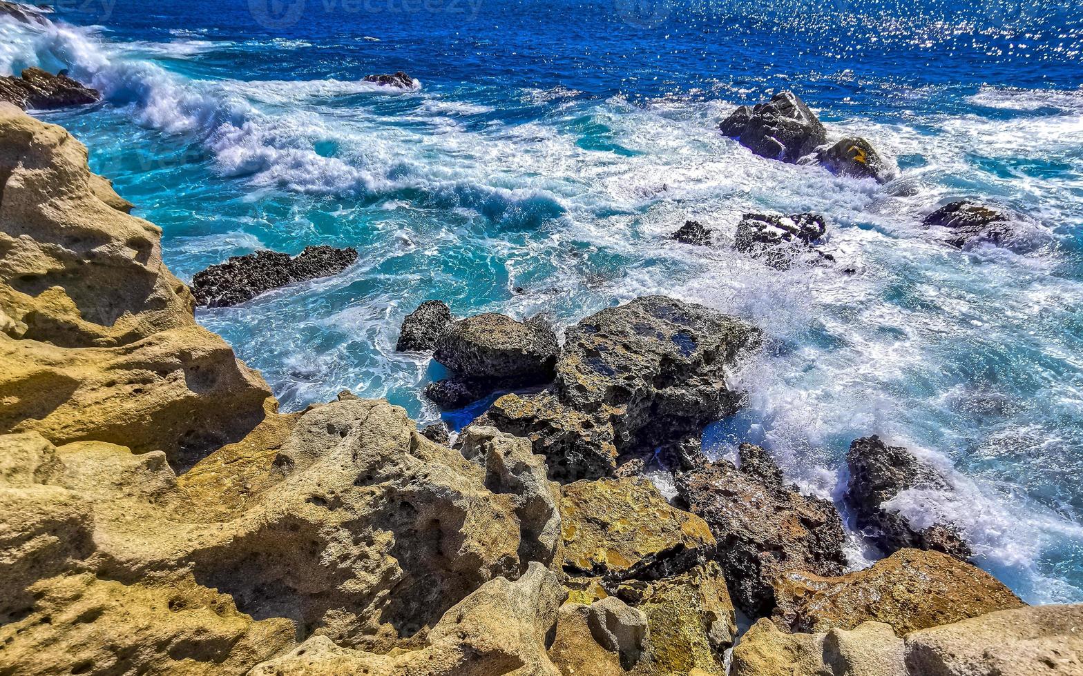 Beautiful rocks cliffs view waves at beach Puerto Escondido Mexico. photo