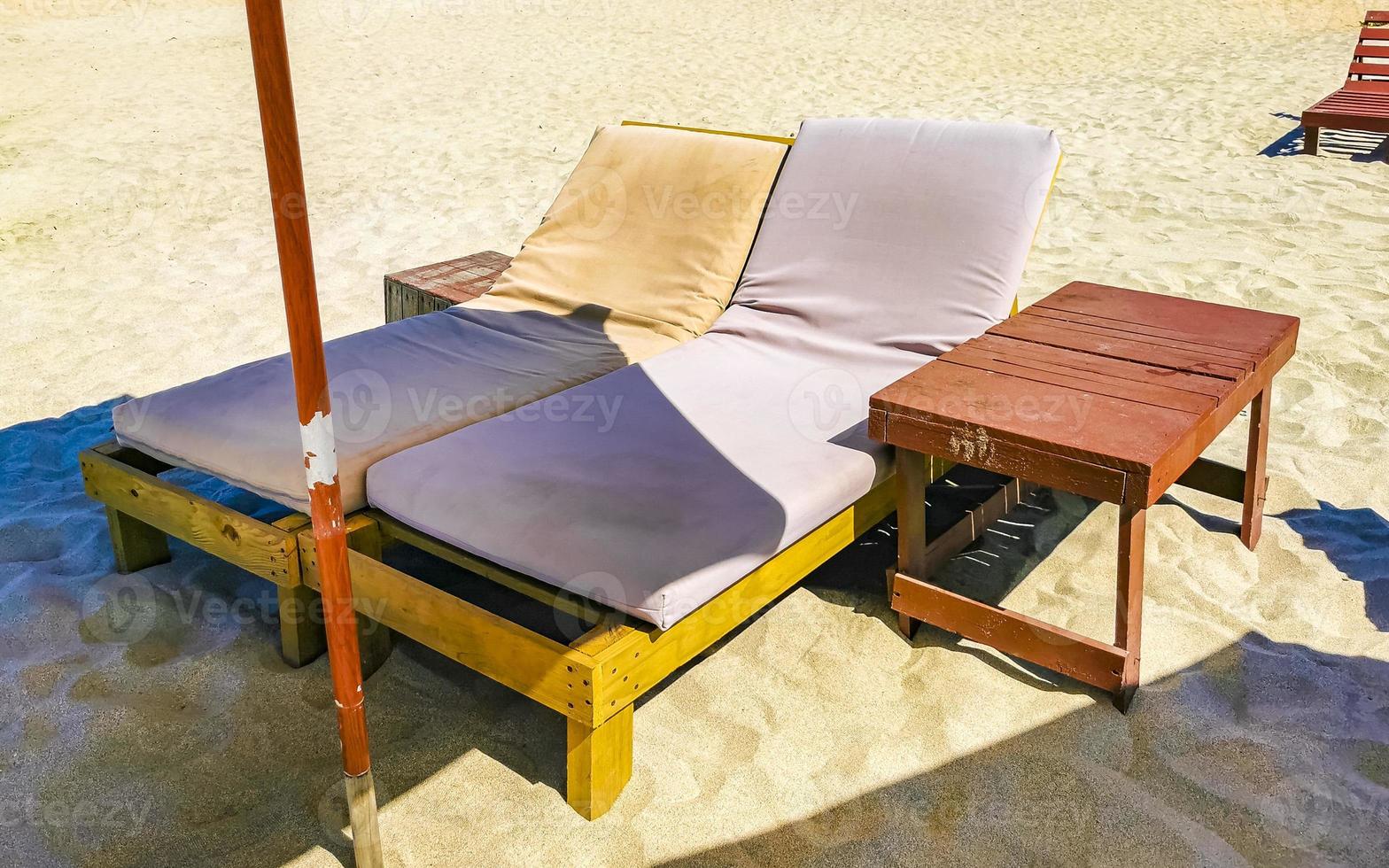 Palms parasols sun loungers beach waves Puerto Escondido Mexico. photo