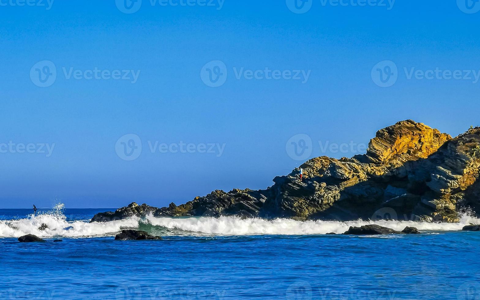 Beautiful rocks cliffs surfer waves at beach Puerto Escondido Mexico. photo