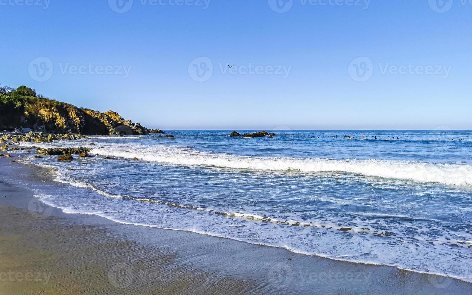 Beautiful rocks cliffs surfer waves at beach Puerto Escondido Mexico. photo