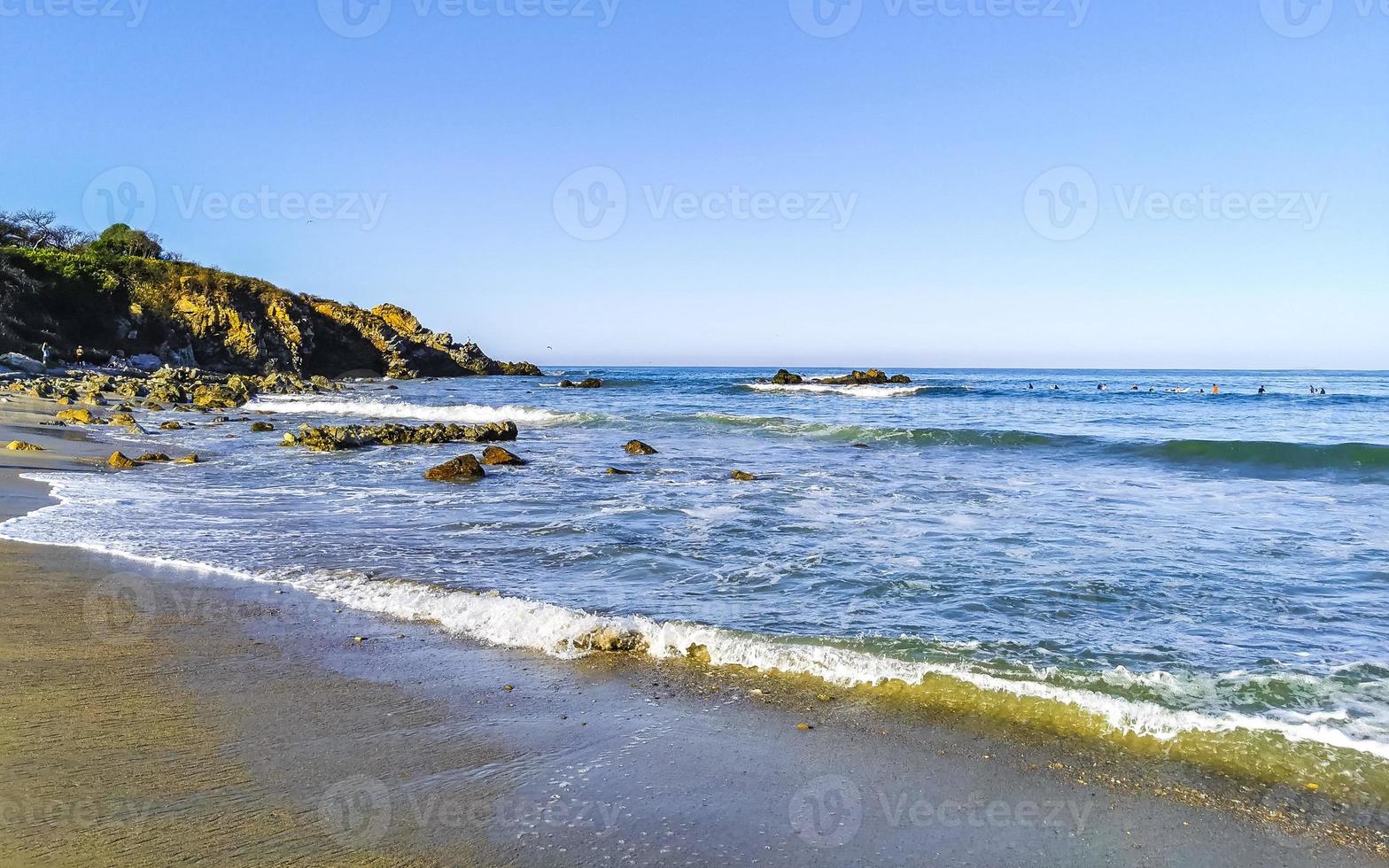 Beautiful rocks cliffs surfer waves at beach Puerto Escondido Mexico. photo