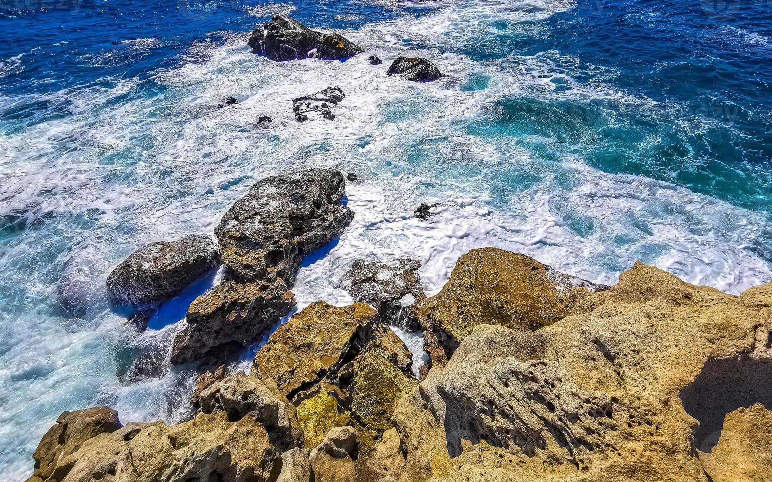 Beautiful rocks cliffs view waves at beach Puerto Escondido Mexico. photo