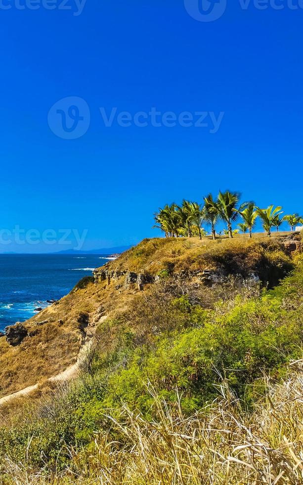 Beautiful rocks cliffs view waves at beach Puerto Escondido Mexico. photo