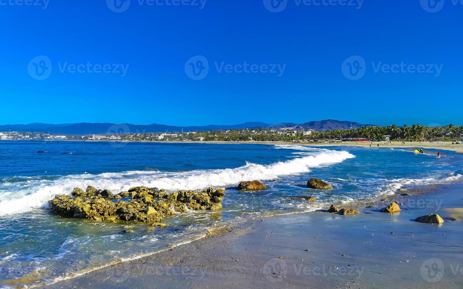 Beautiful rocks cliffs surfer waves at beach Puerto Escondido Mexico. photo