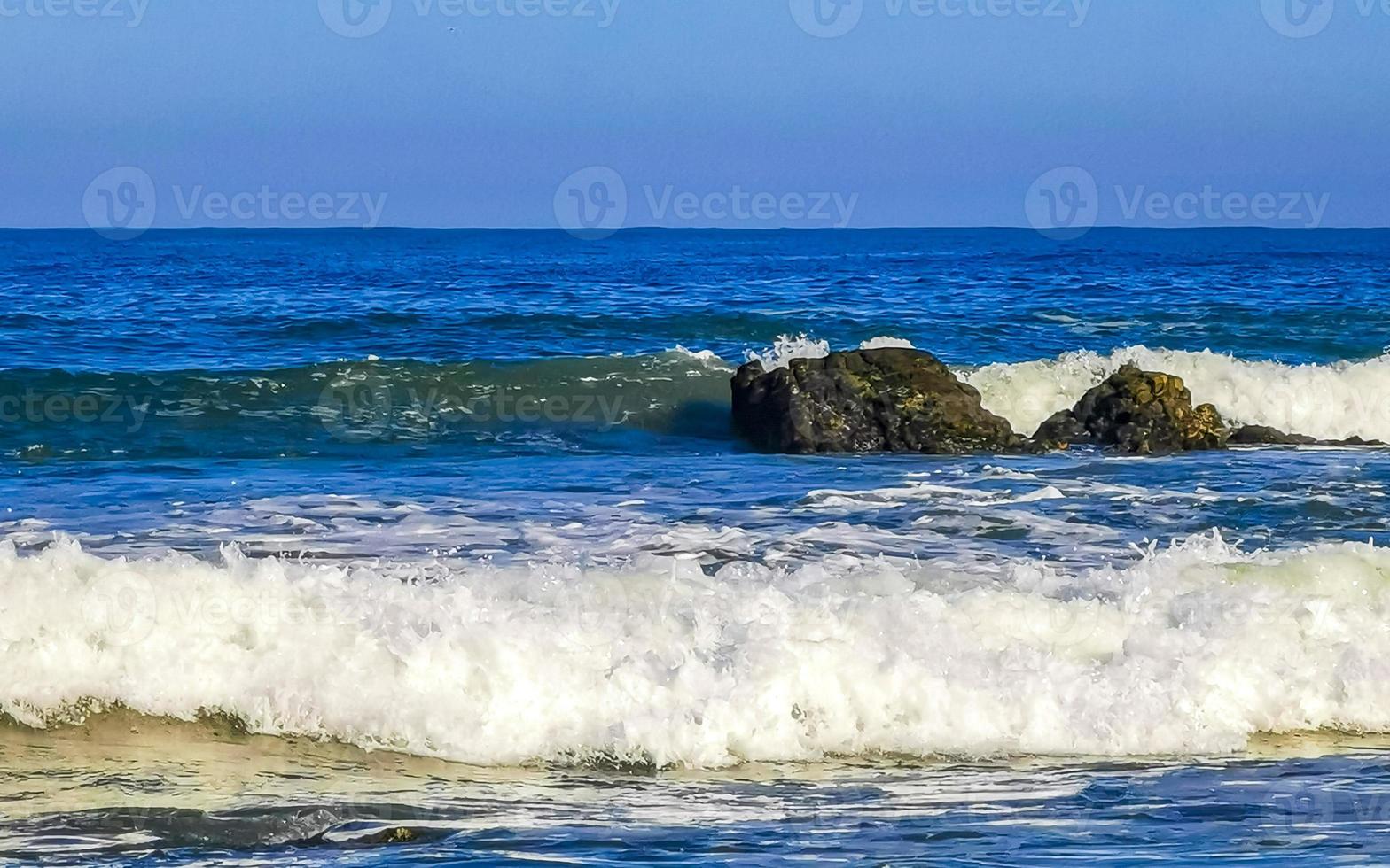 Beautiful rocks cliffs surfer waves at beach Puerto Escondido Mexico. photo