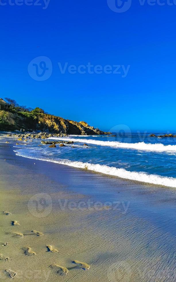 Beautiful rocks cliffs surfer waves at beach Puerto Escondido Mexico. photo