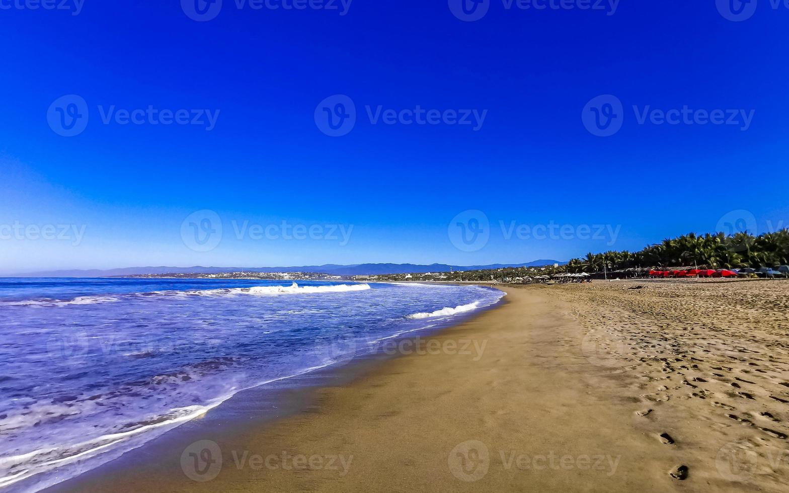 Sun beach sand people waves palms in Puerto Escondido Mexico. photo