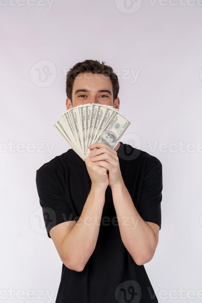 Portrait of a cheerful man holding dollar bills over white background photo