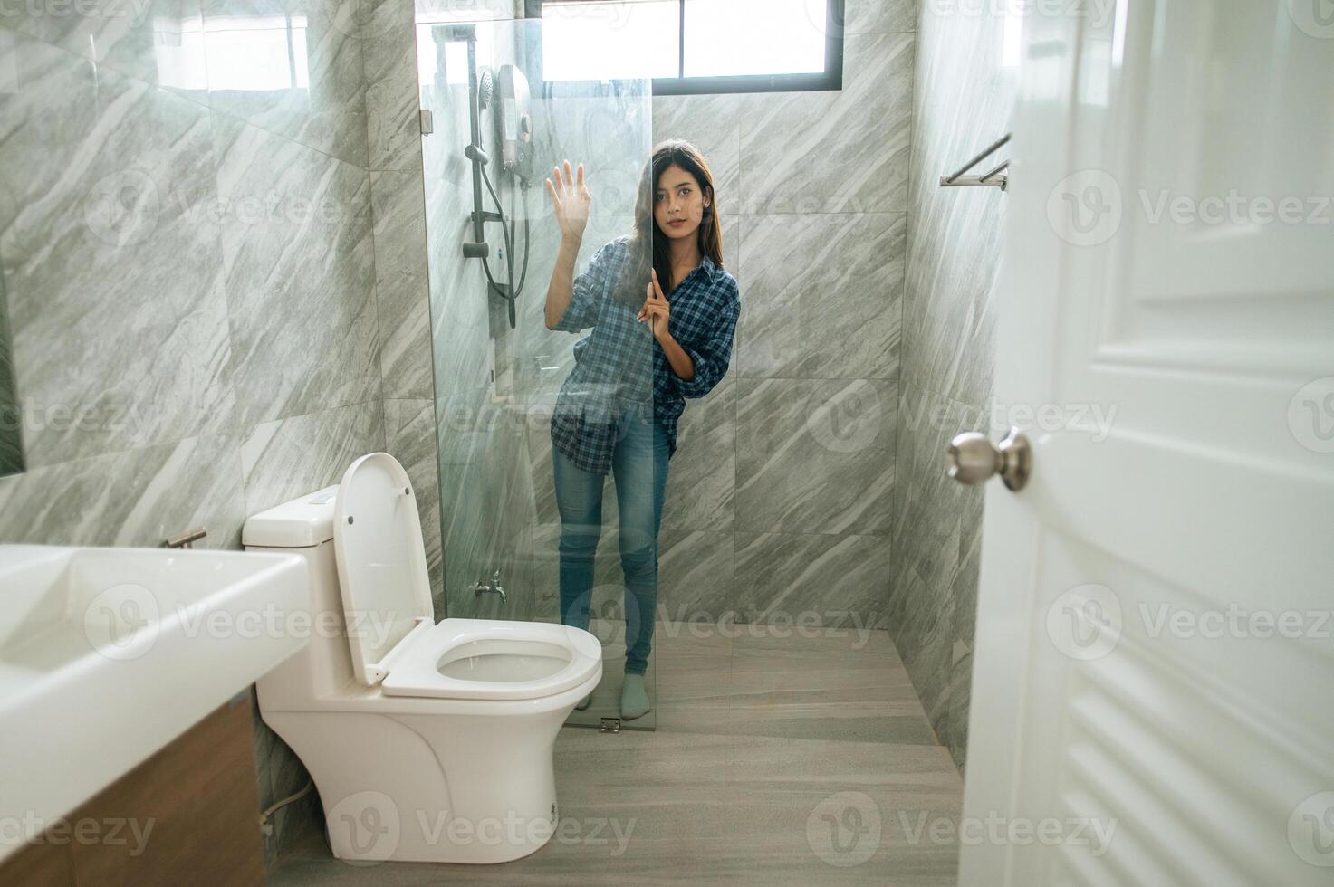 Young woman in bathroom and restroom photo