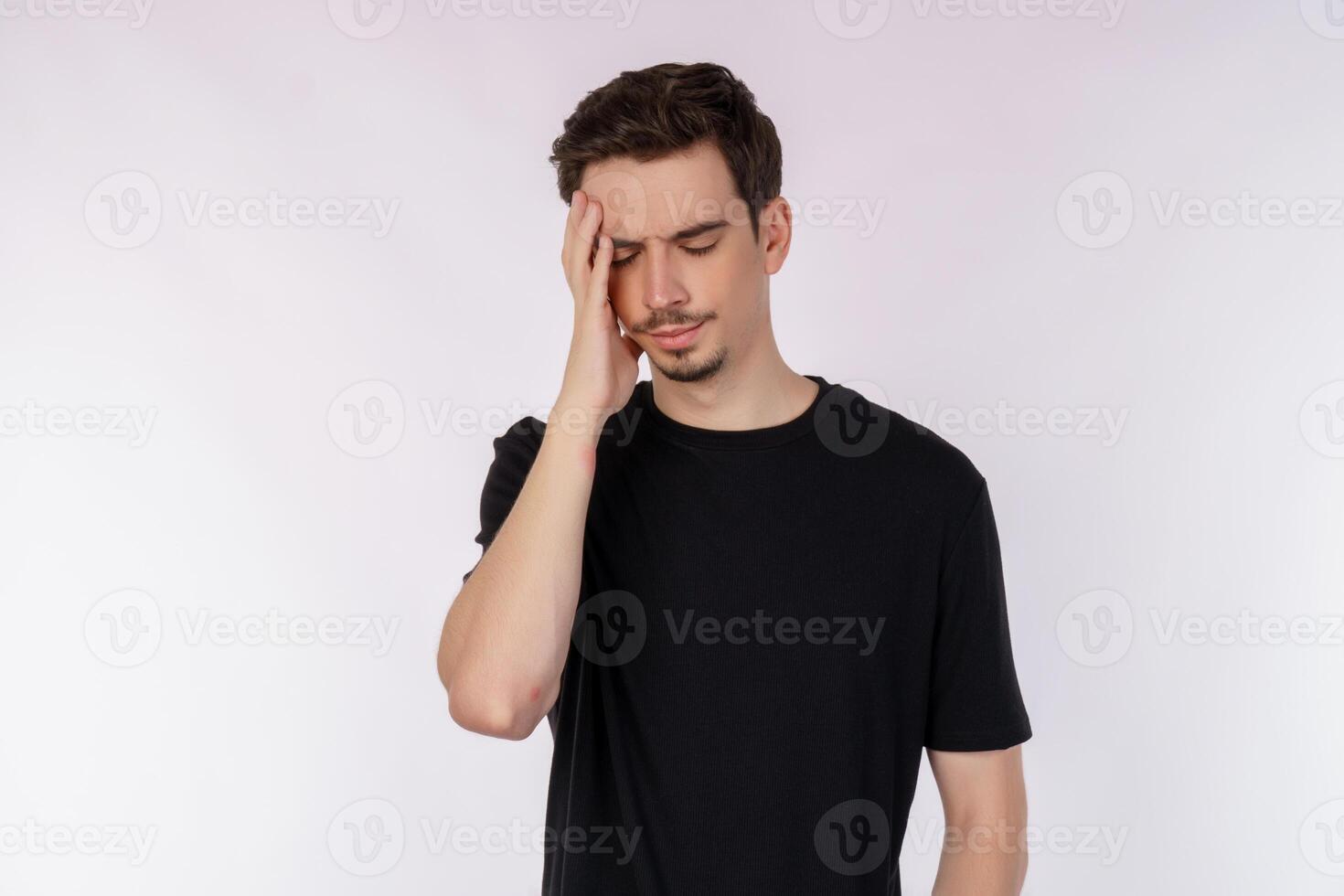 Portrait of thinking man surrounded by question mark on isolated background photo