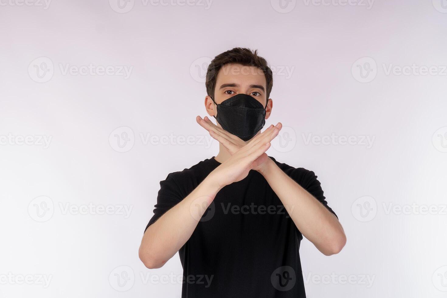 Portrait of young handsome man wearing medical mask doing stop sing with palm of the hand over white background photo