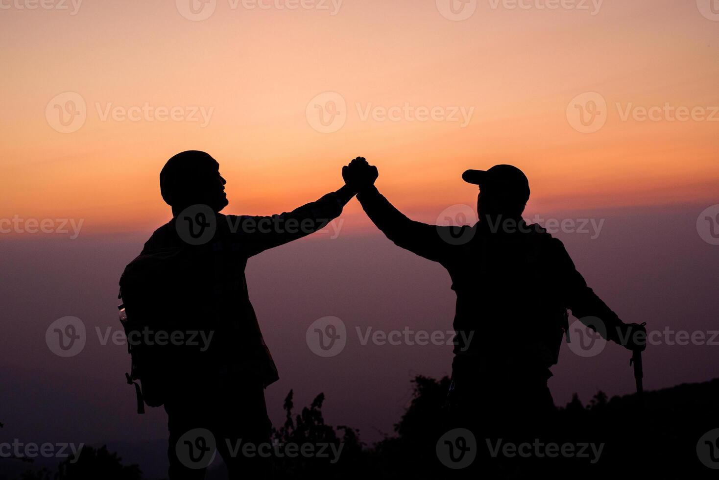Silhouette of Teamwork helping hand trust help photo