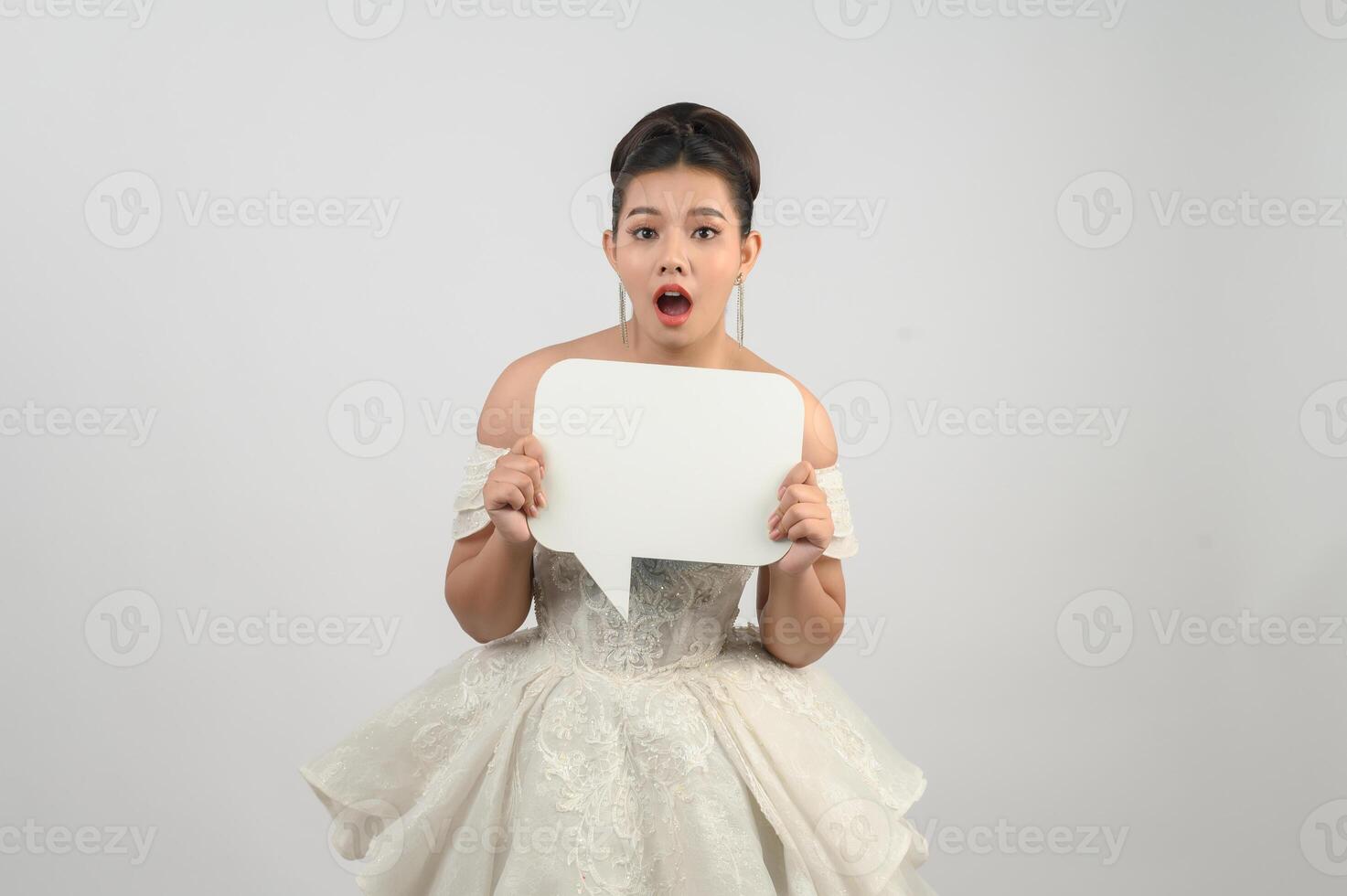 joven asiática hermosa novia posa con pancarta de maqueta en la mano foto