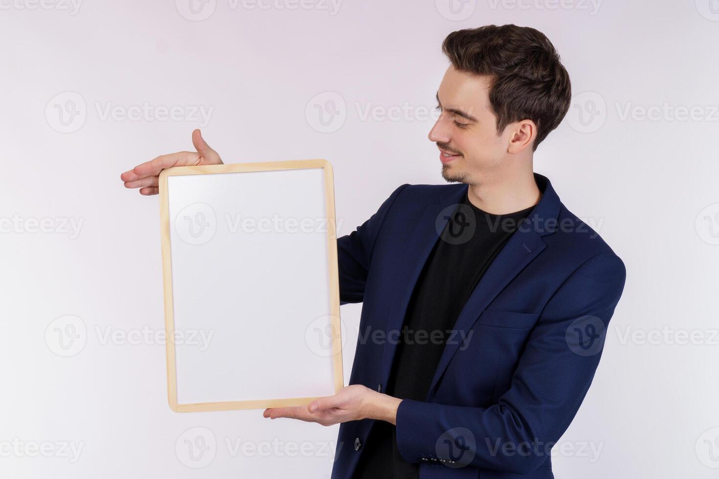 Portrait of happy businessman showing blank signboard on isolated white background photo