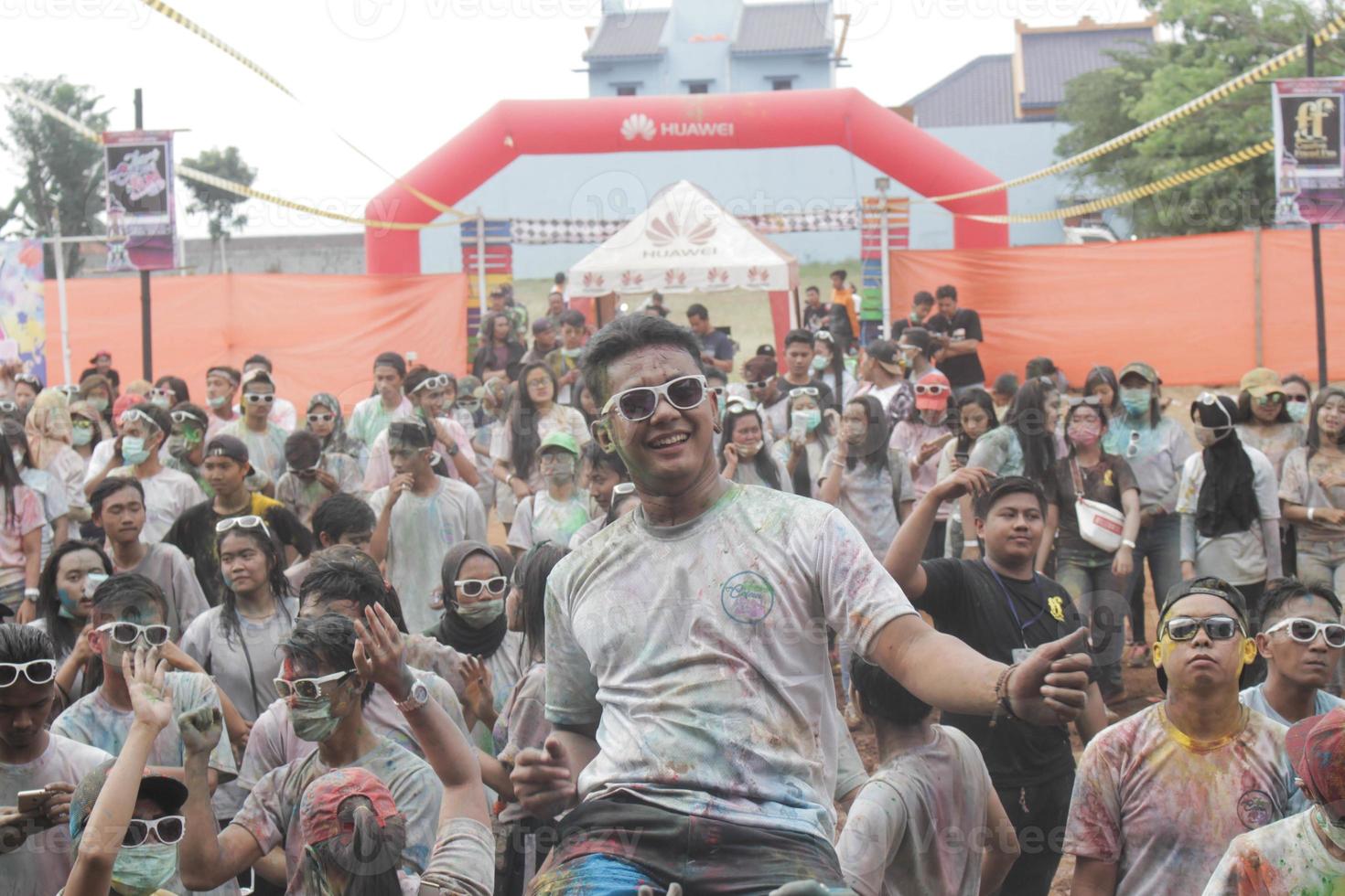 Asian youth celebrate a party by sprinkling color powder in Central Java, Indonesia. photo