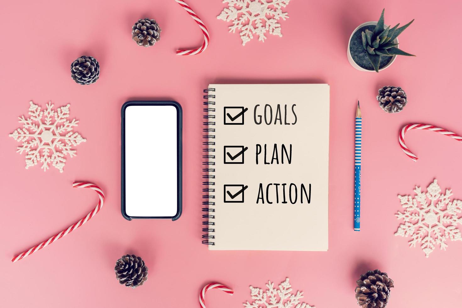 Notebooks with empty goals, plan, action and christmas decorations on color background photo