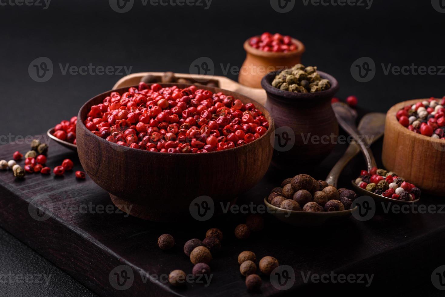 Composition, concept, consisting of several types of different colors of allspice in bowls and spoons photo