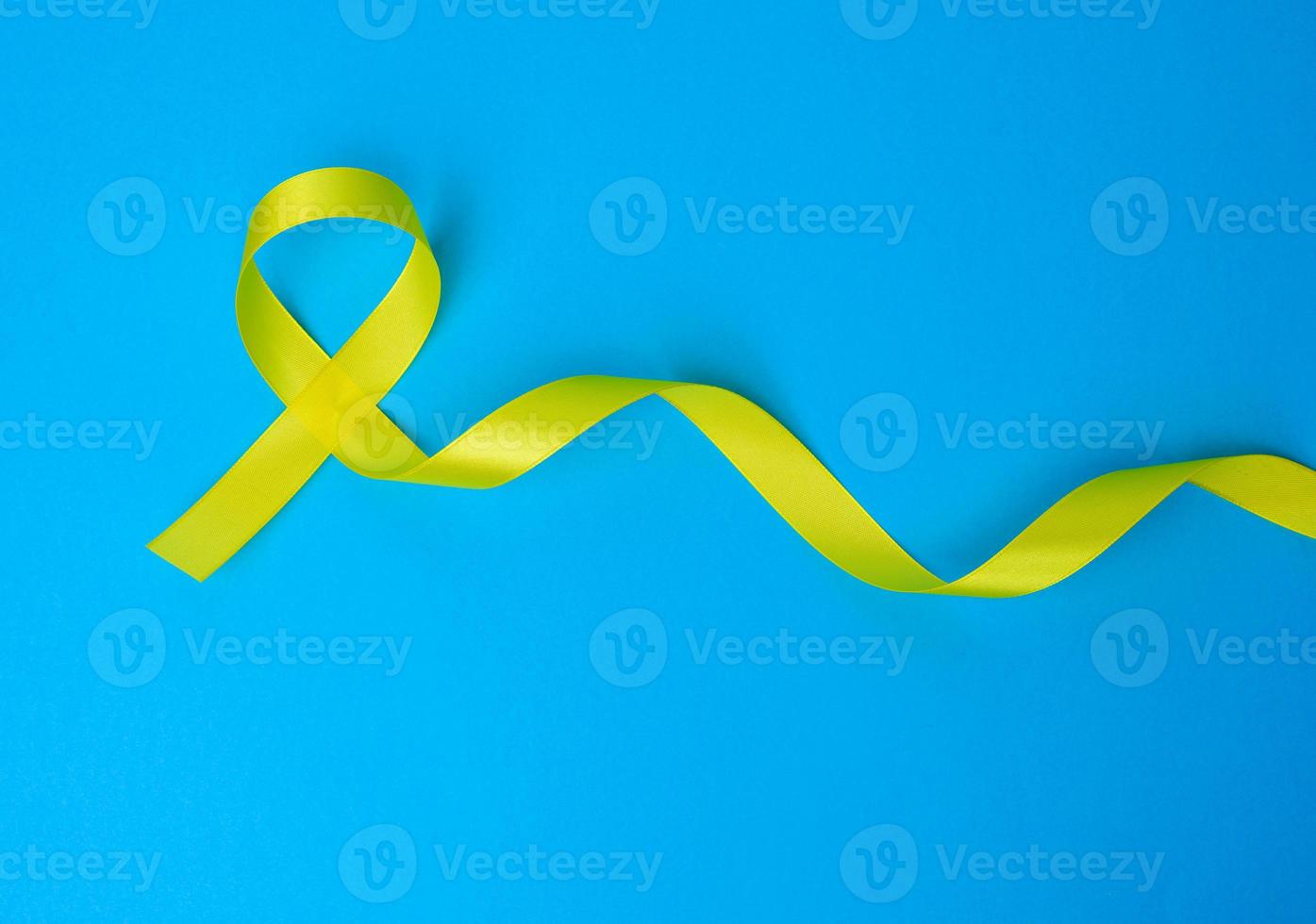 yellow silk ribbon loop on a blue background photo