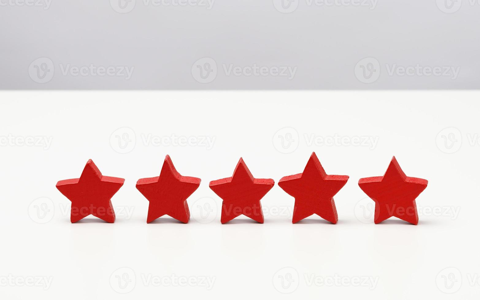 wooden five star shape on table. Best excellent business services rating customer experience concept, white table photo