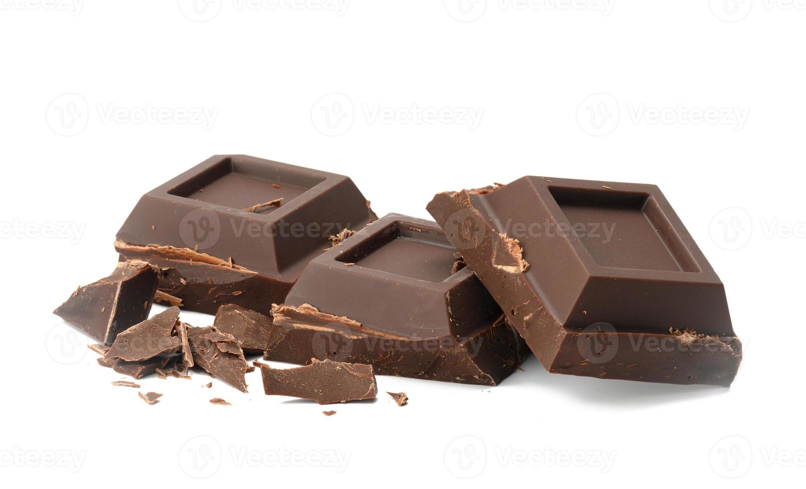 broken black chocolate with pieces isolated on white background. Dessert bar of chocolate, close up photo
