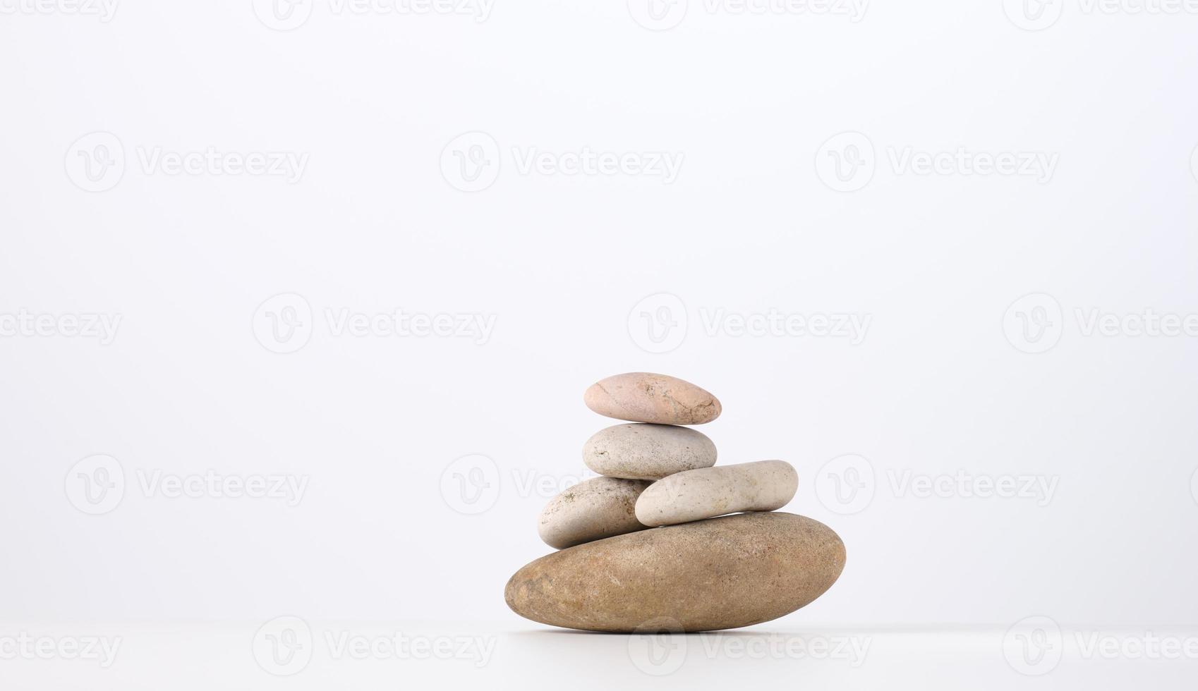 stack of round stones on a white background. Scene for demonstration of cosmetic products photo