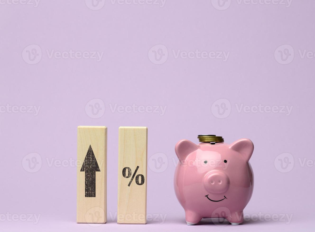 pink ceramic piggy bank and wooden blocks with an arrow at the top photo