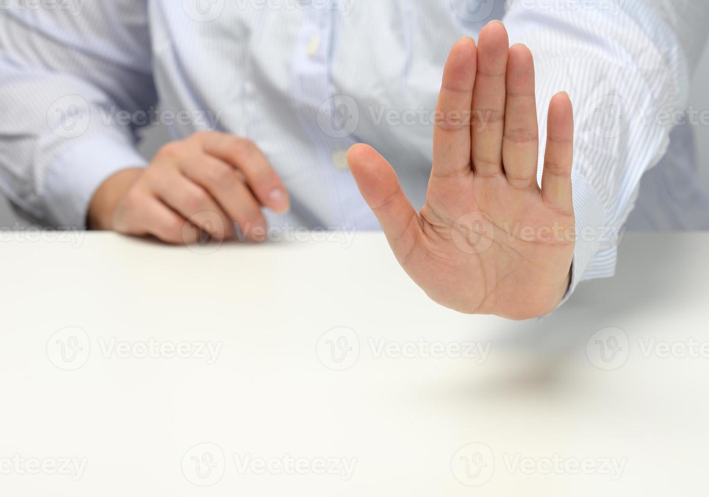 woman in blue striped shirt shows no gesture. Refusal and please do not disturb photo