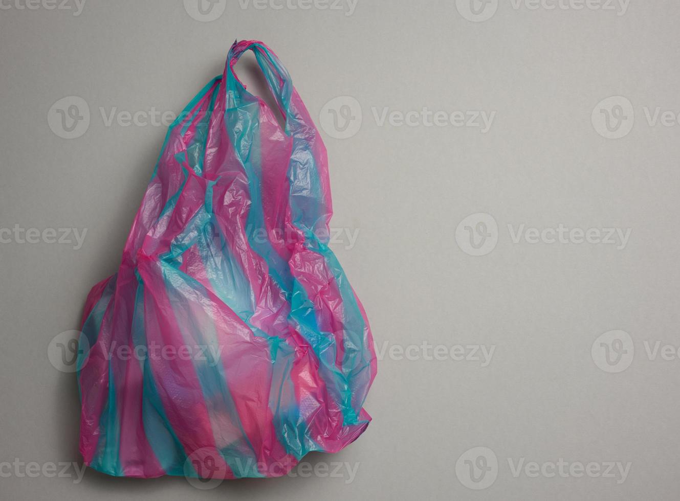 full plastic bag on gray background, top view photo