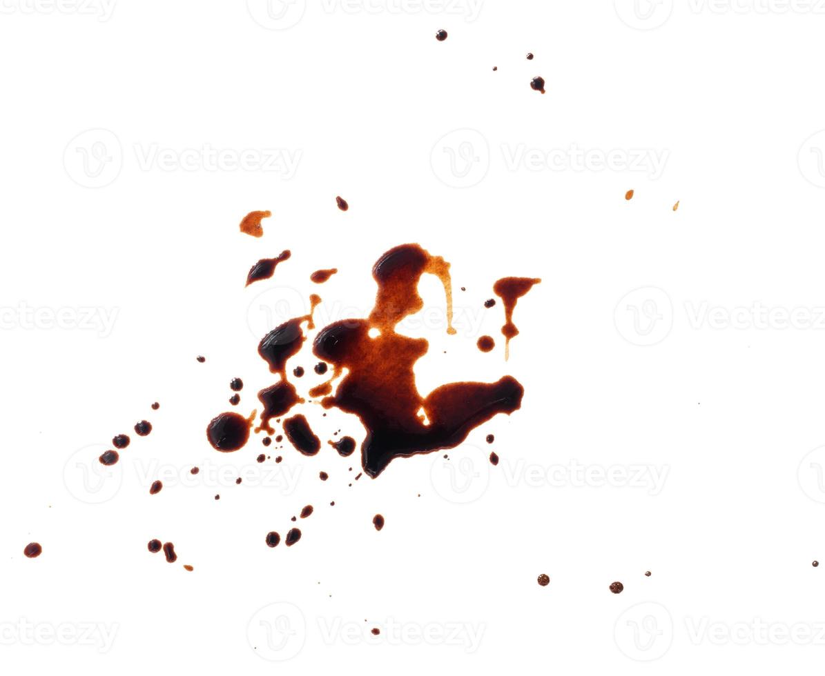 spilled black coffee on a white background. Large brown blot with fine splashes photo