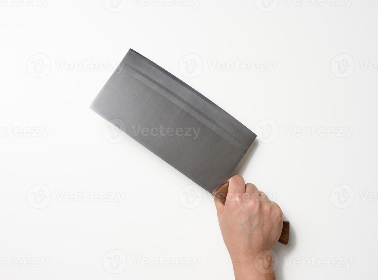 female hand holding a large sharp kitchen knife for cutting meat on a white background photo