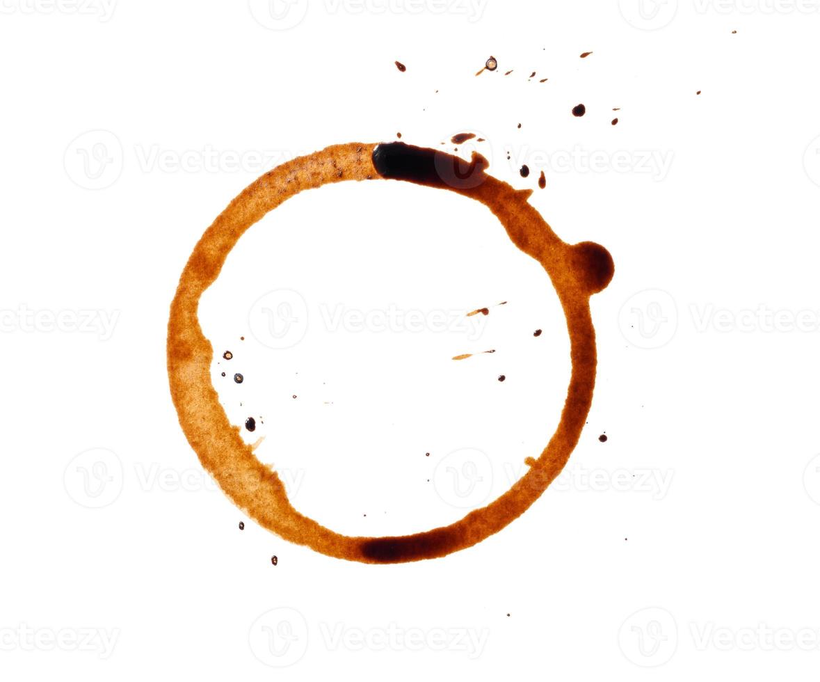 spilled black coffee on a white background. Round blotprint from the bottom of the cup with fine splashes photo