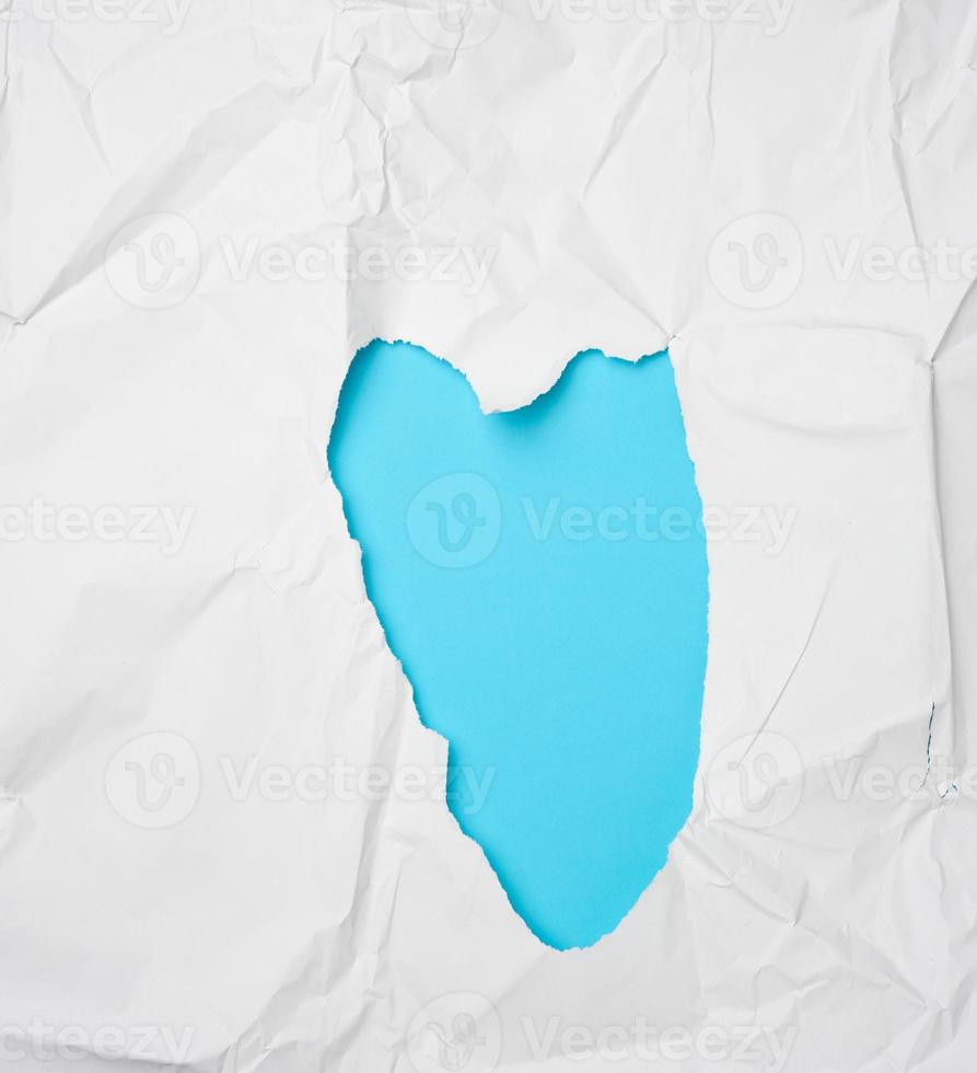 crumpled white paper with a heart-shaped hole photo