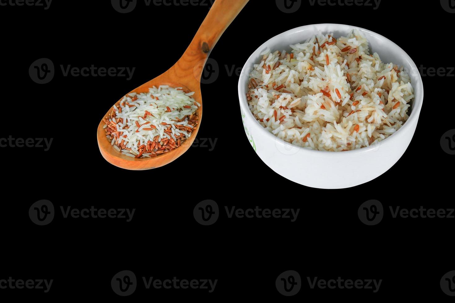 rice white and brown  in the cup in wood spoon Close up on black background photo