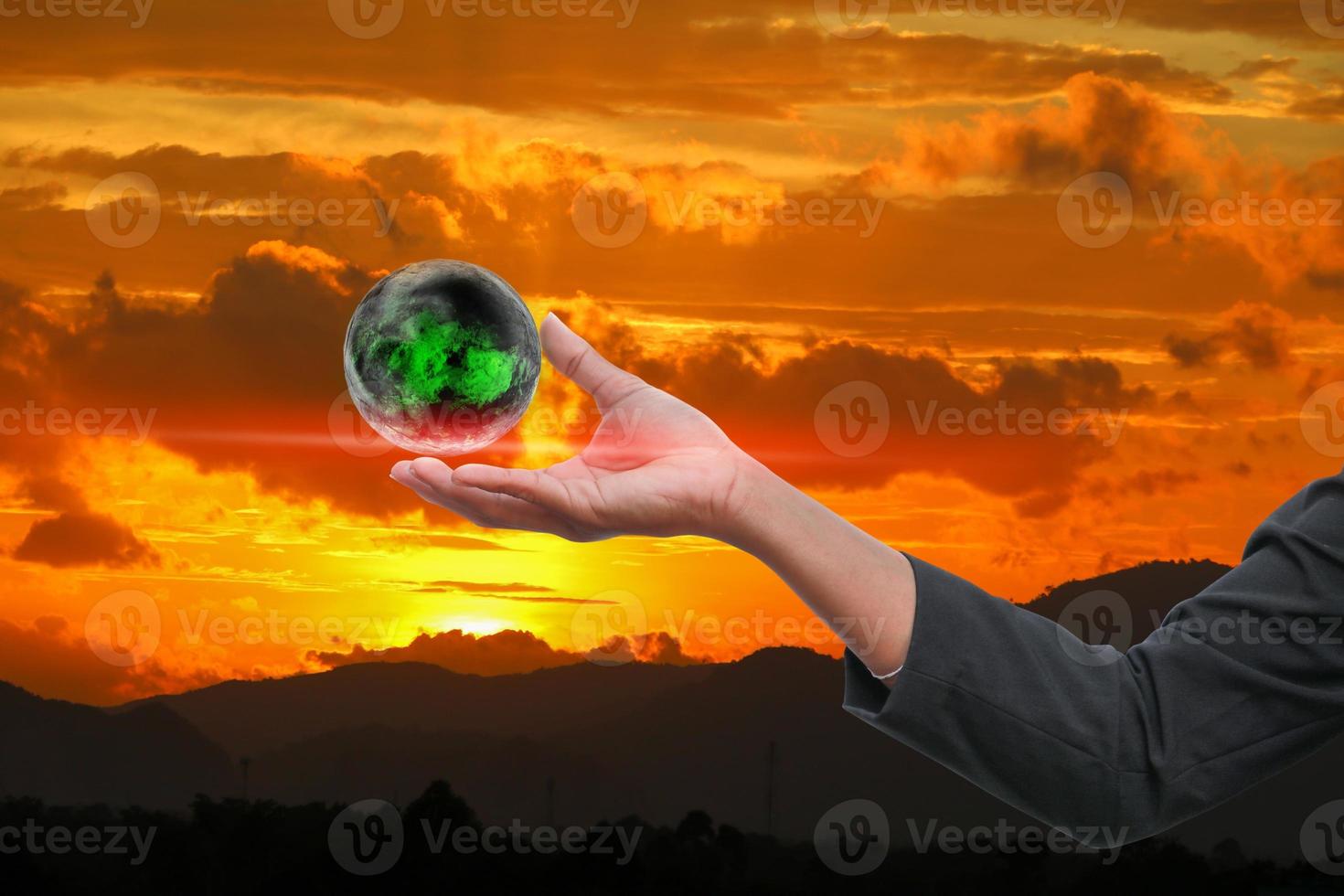 business man receiving hand holding the world in  palm of  idea  on sky red  background photo