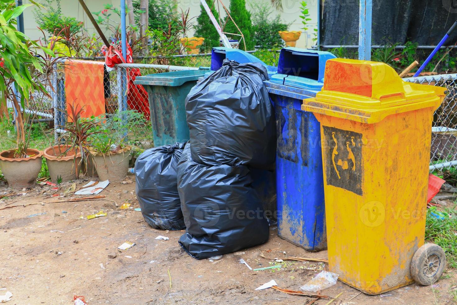 Pile black garbage bag roadside in the city photo