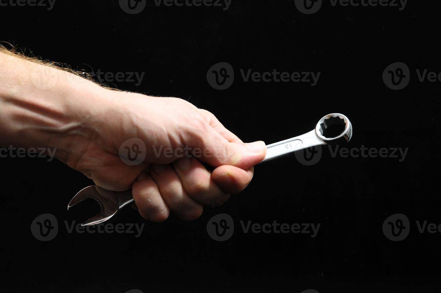 Hand holding a wrench photo