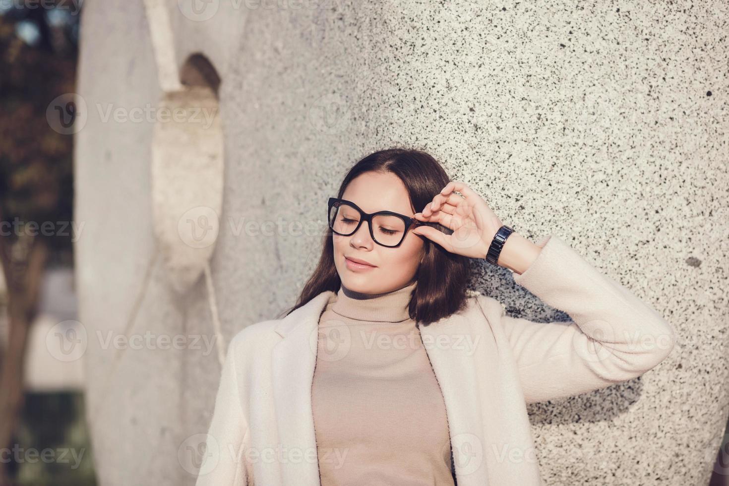 woman wears coat and glasses photo