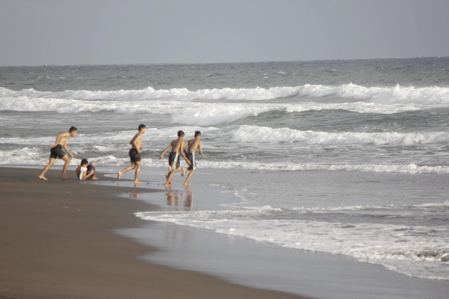 photo of black sand beach during the day