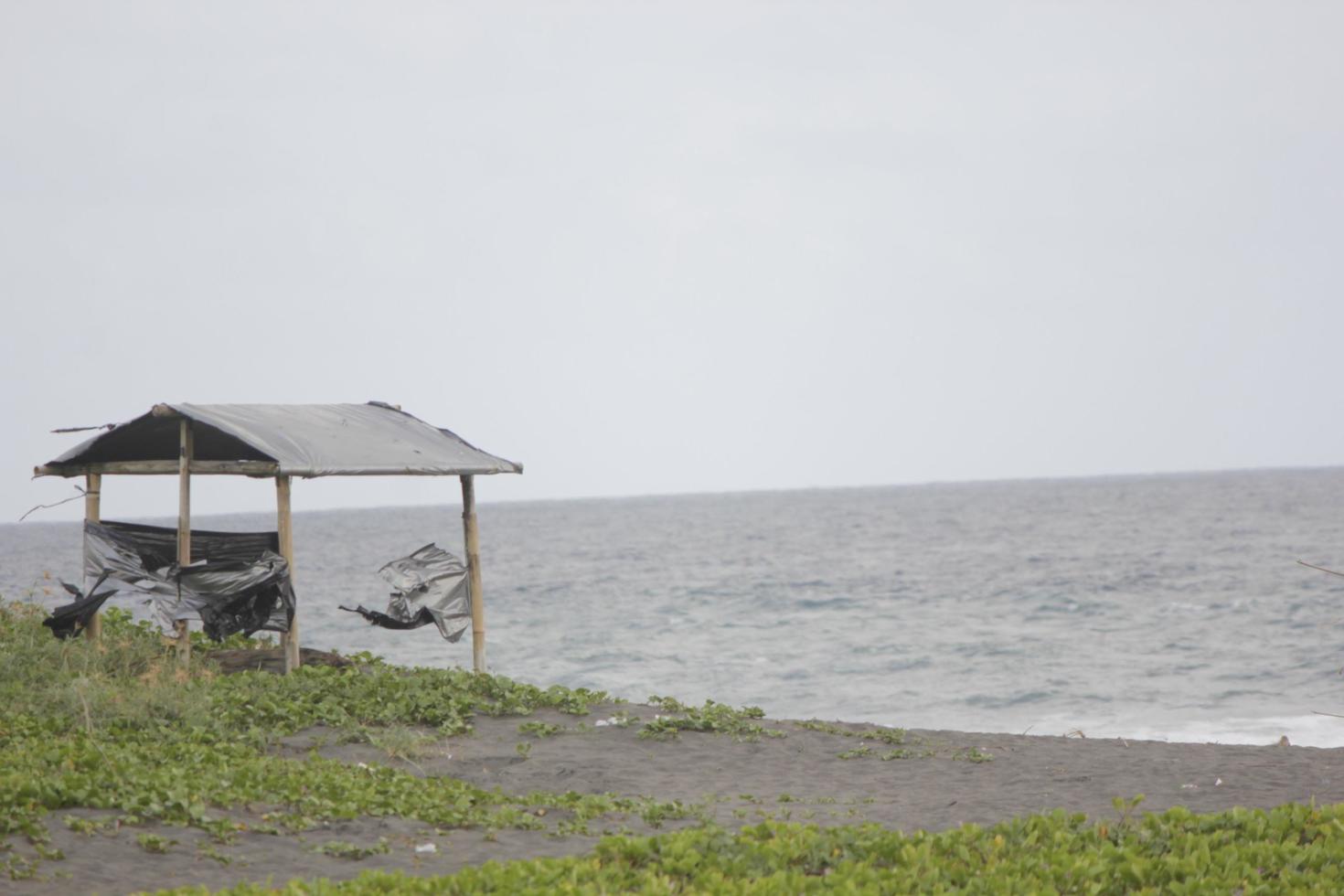 photo of a hut on the beach during the day