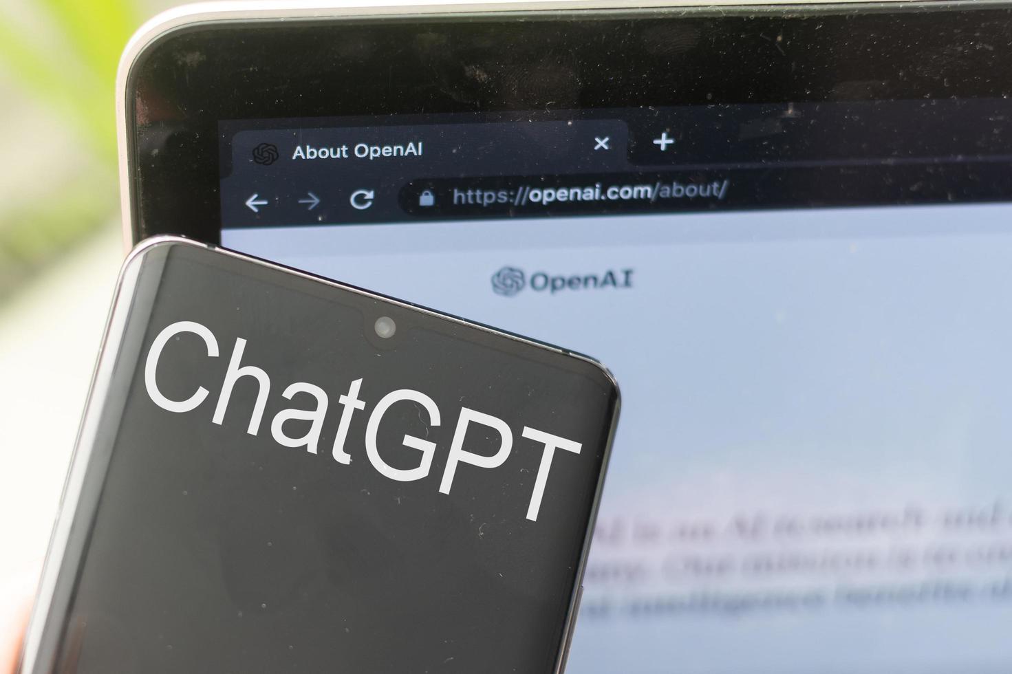 Mobile phone with website of US artificial intelligence company OpenAI LLC on screen in front of business logo. Focus on top-left of phone display. Kyiv, Ukraine - February 08, 2023 photo