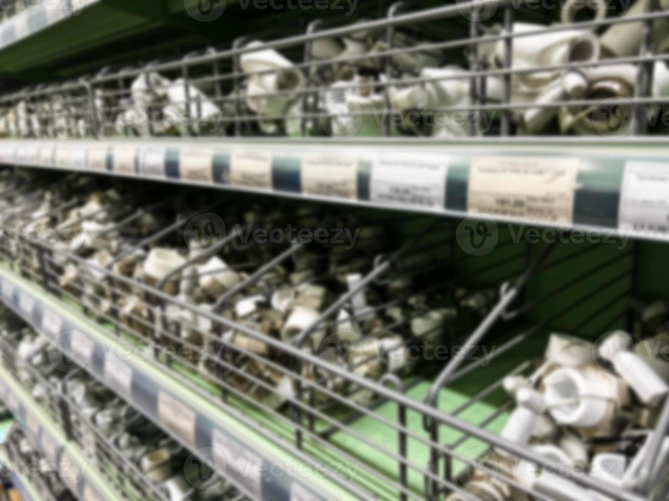 A blurry image of a hardware store with paints, varnish, brushes in a building materials store as a trading background. For the photo