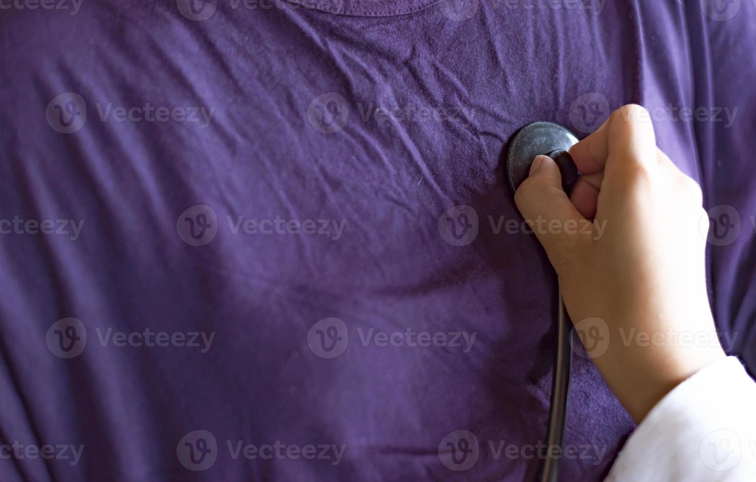 Medical concept.The doctor is checking the patient pulse.Health check.The doctor uses stethoscope to listen to the heart rate of the patient. photo