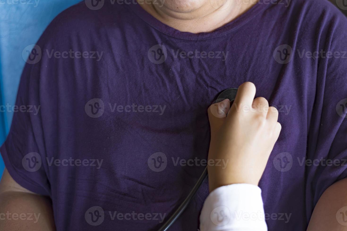 Medical concept.The doctor is checking the patient pulse.Health check.The doctor uses stethoscope to listen to the heart rate of the patient. photo