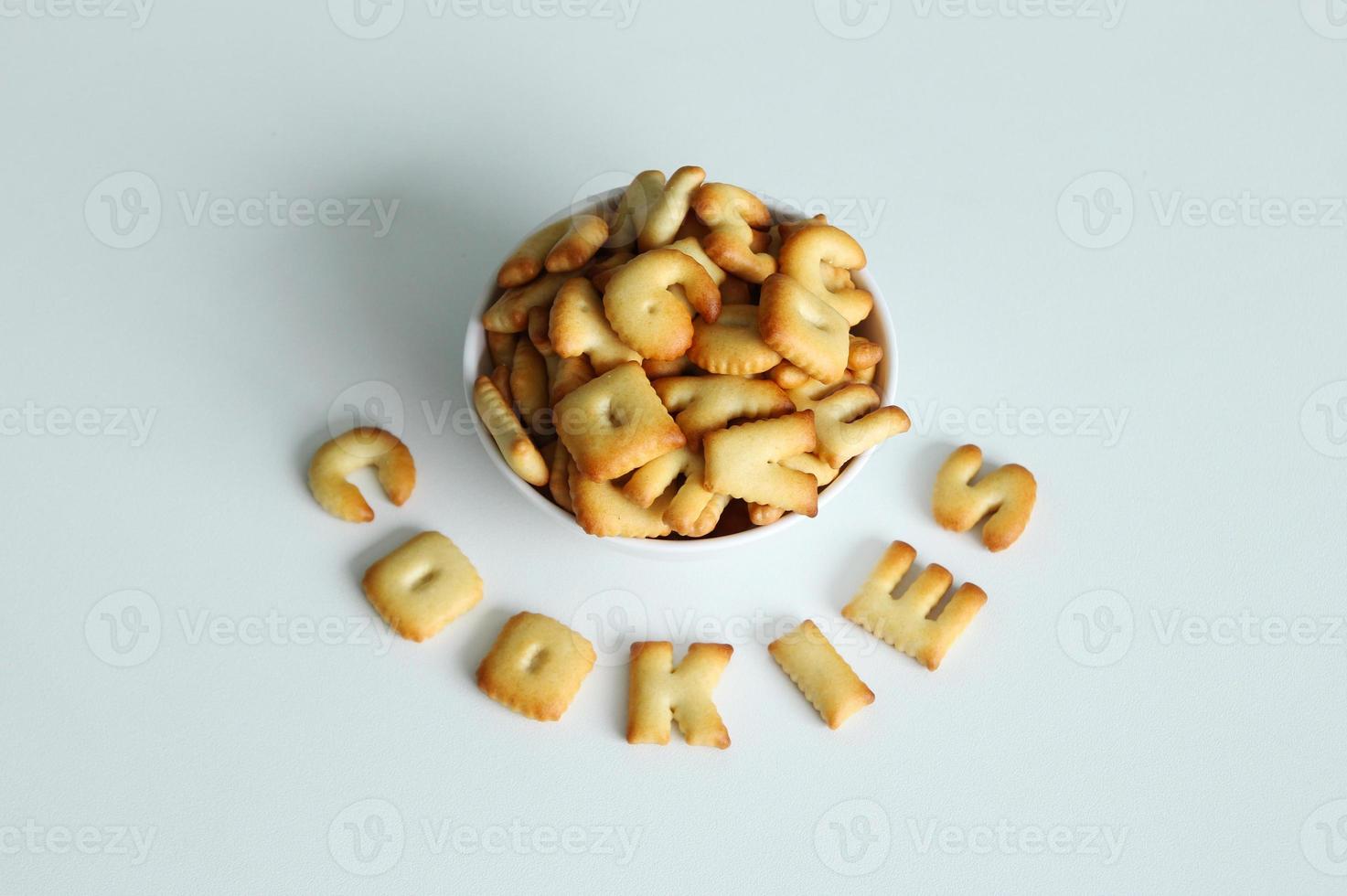 A bowl of cookies with inscription from the cookies on the white background. photo