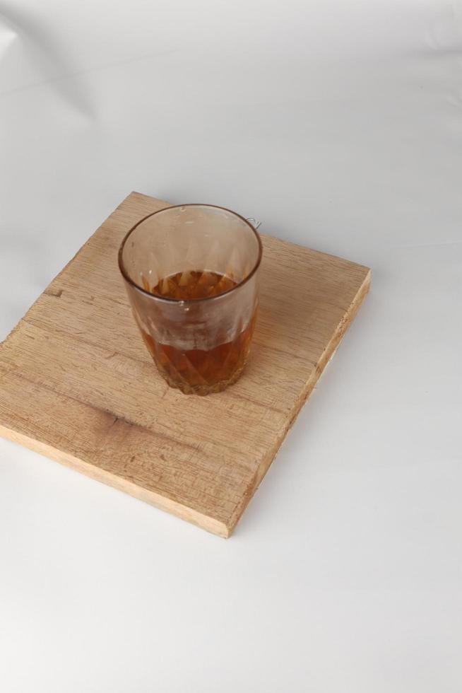 a glass of warm tea on a white background photo