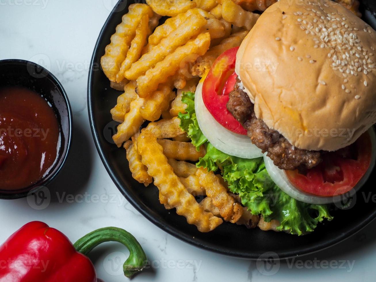 Homemade pork hamburger with fresh lettuce, tomato, fried egg, fresh onion photo